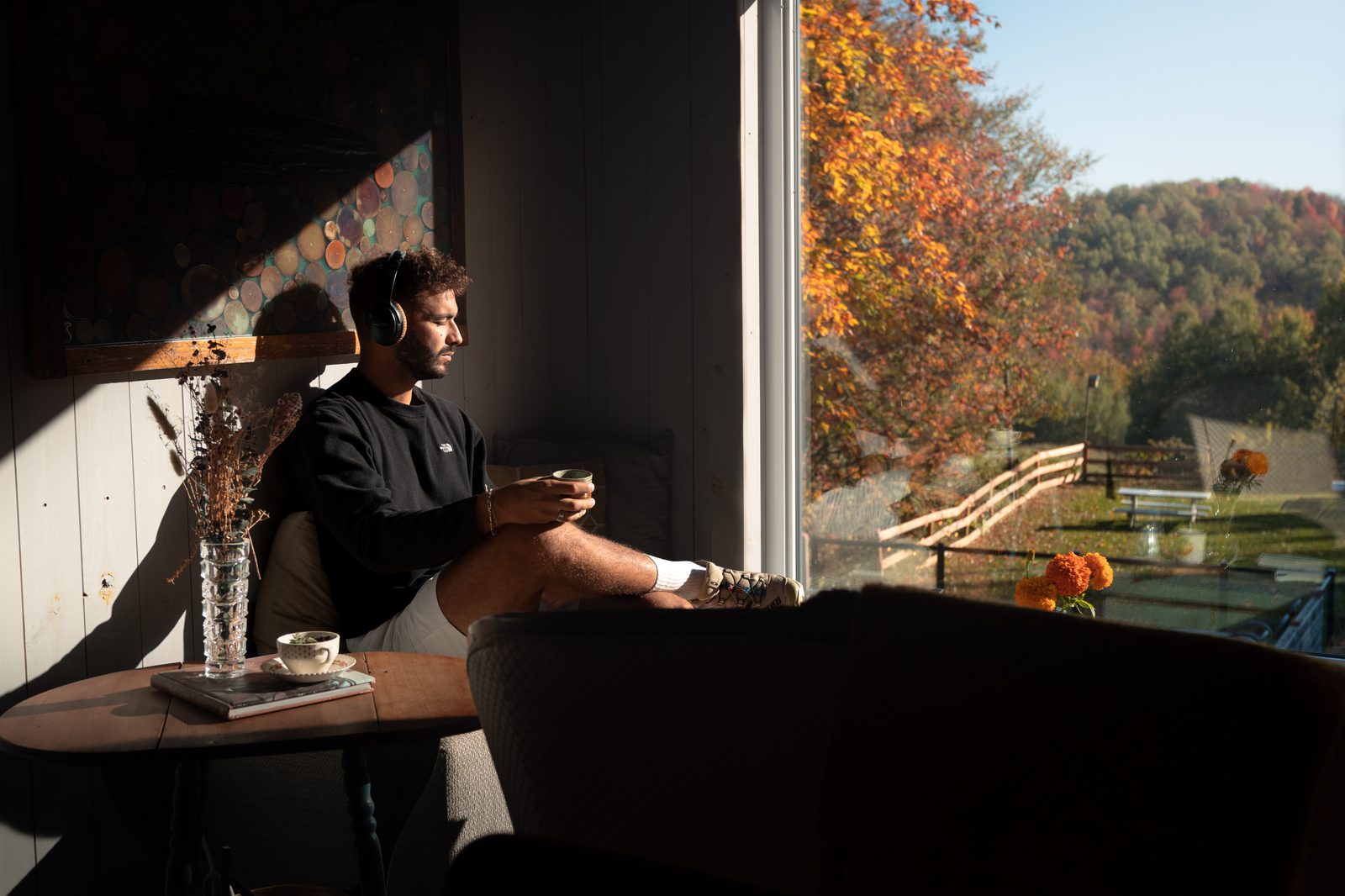 Client détendu devant la fenêtre panoramique d'un chalet