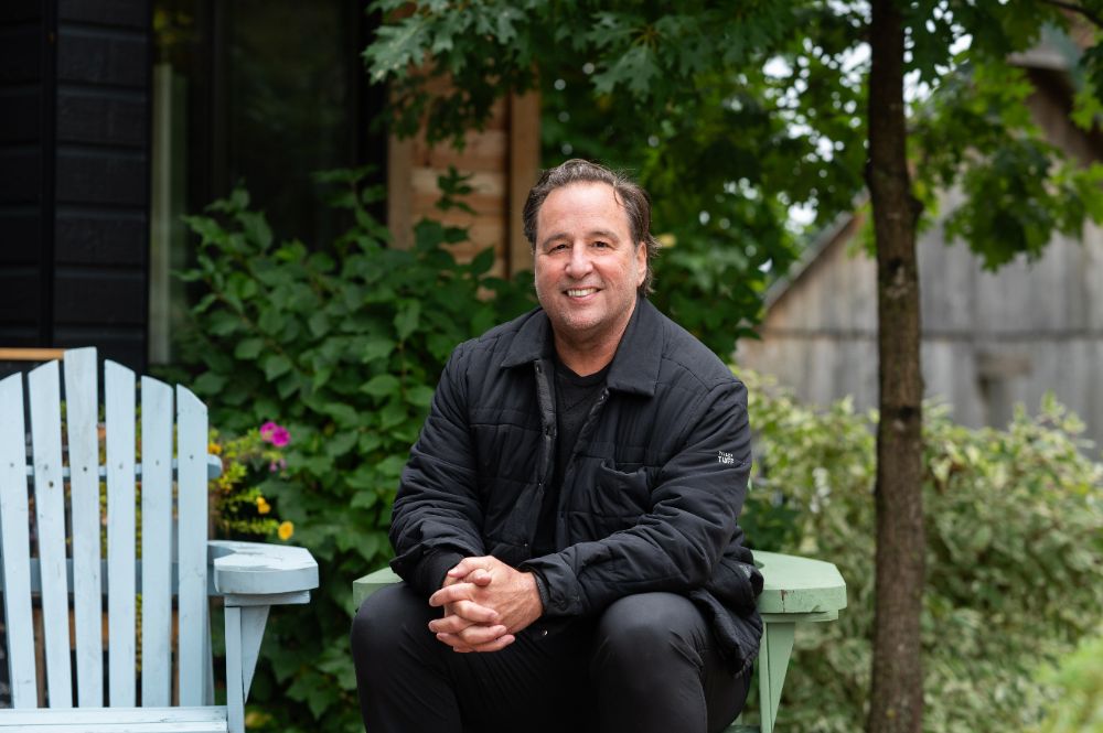 Christian Lefebvre, assis, souriant