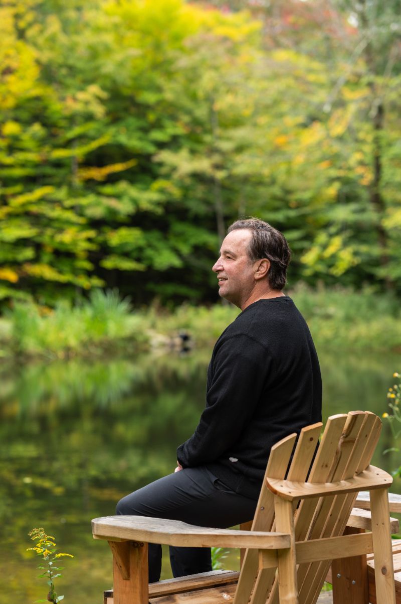 Christian Lefebvre, assis au bord de l'étang